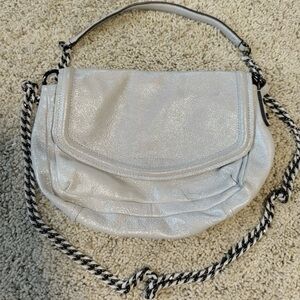 Aimee Kestenberg Metallic Silver Crossbody Bag – Chain Strap, Words Lining